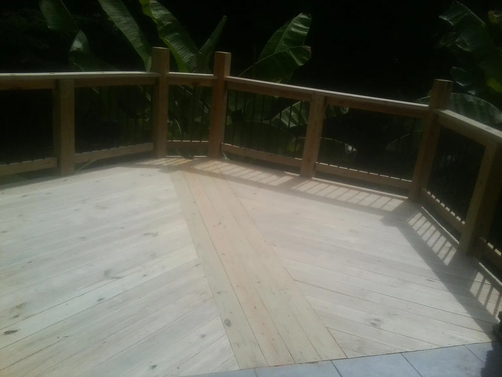 New wood deck and railing built off the back of a home in Waterville
